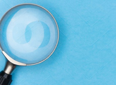 Magnifying glass over blue background